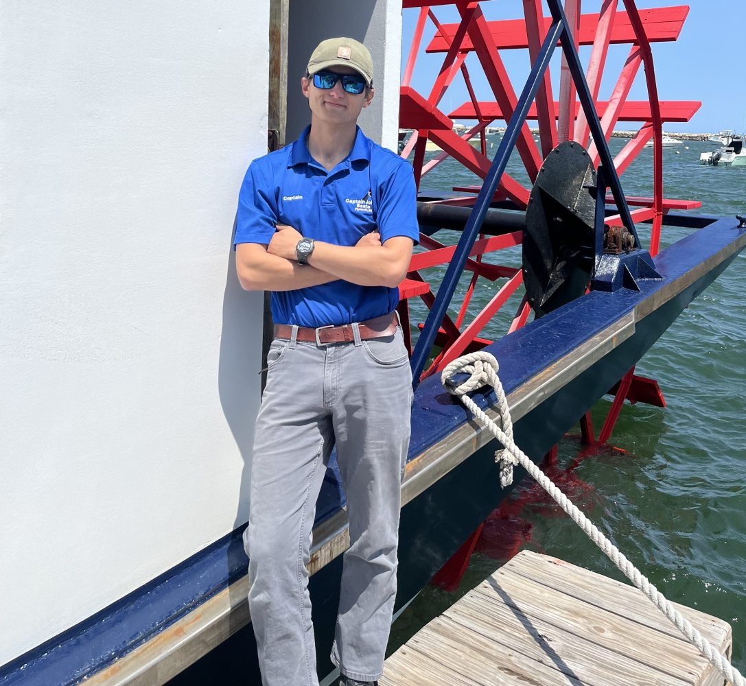 a person standing next to a body of water